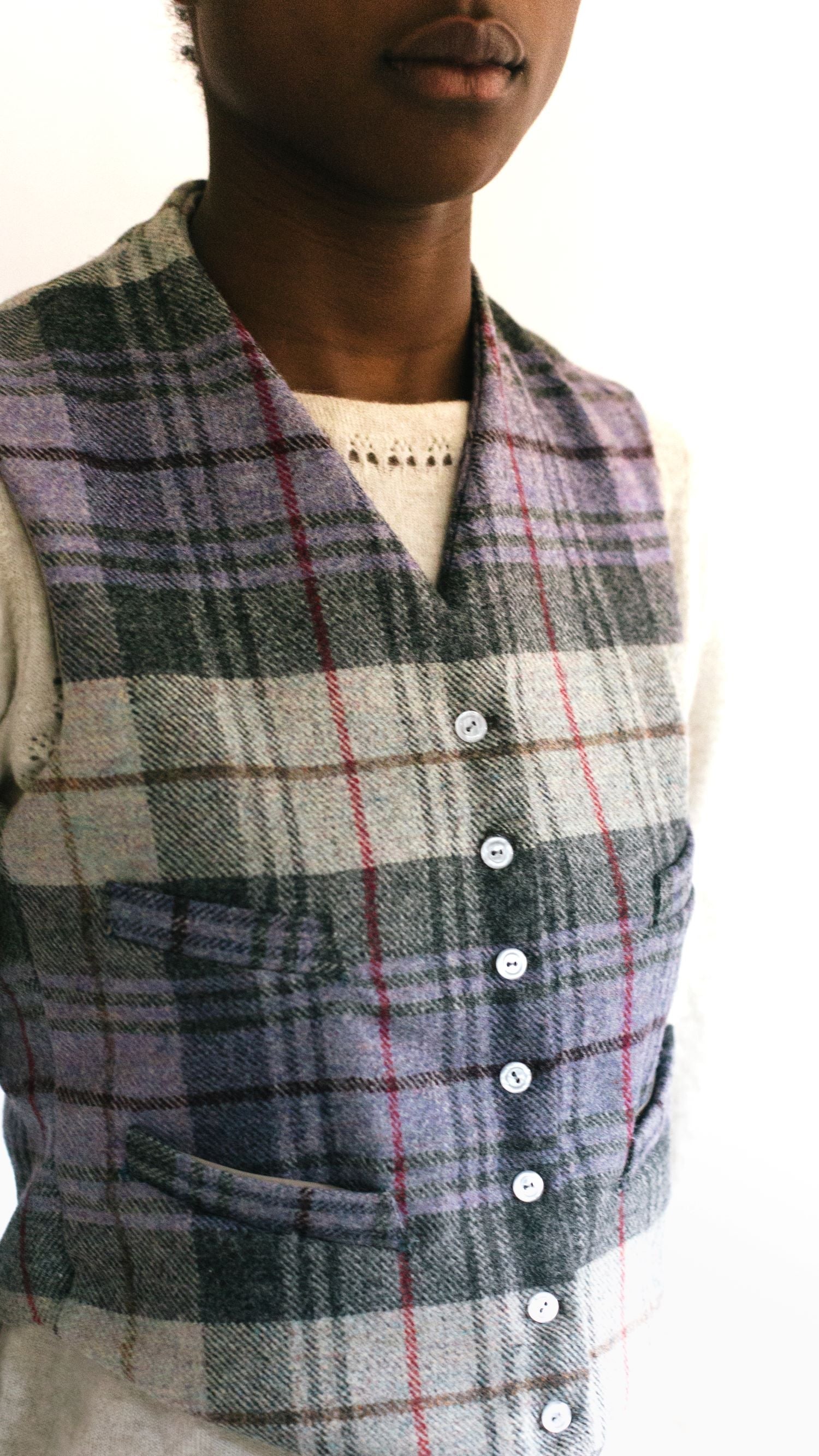 Close up of African woman wearing View C 222 Vintage Vests, collarless and four welts pockets