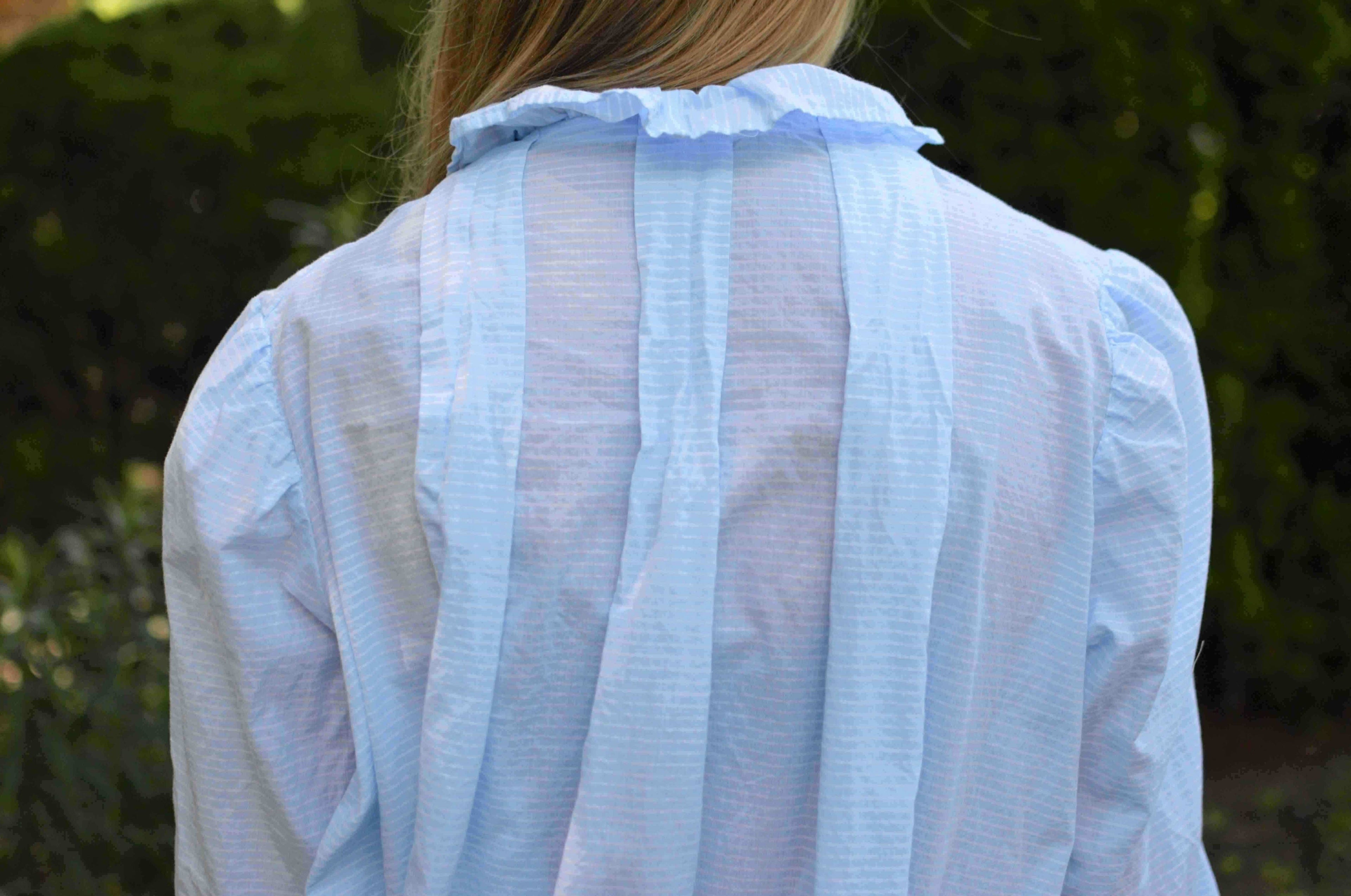 closeup of top of back of blue nightgown with three box pleats.