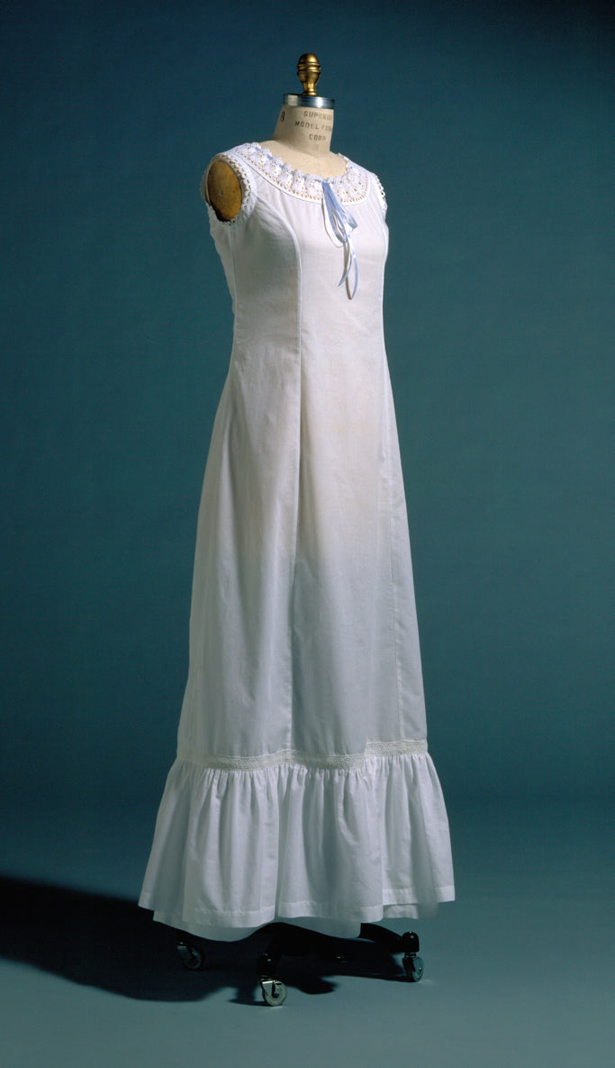 white princess slip on  a dress form.