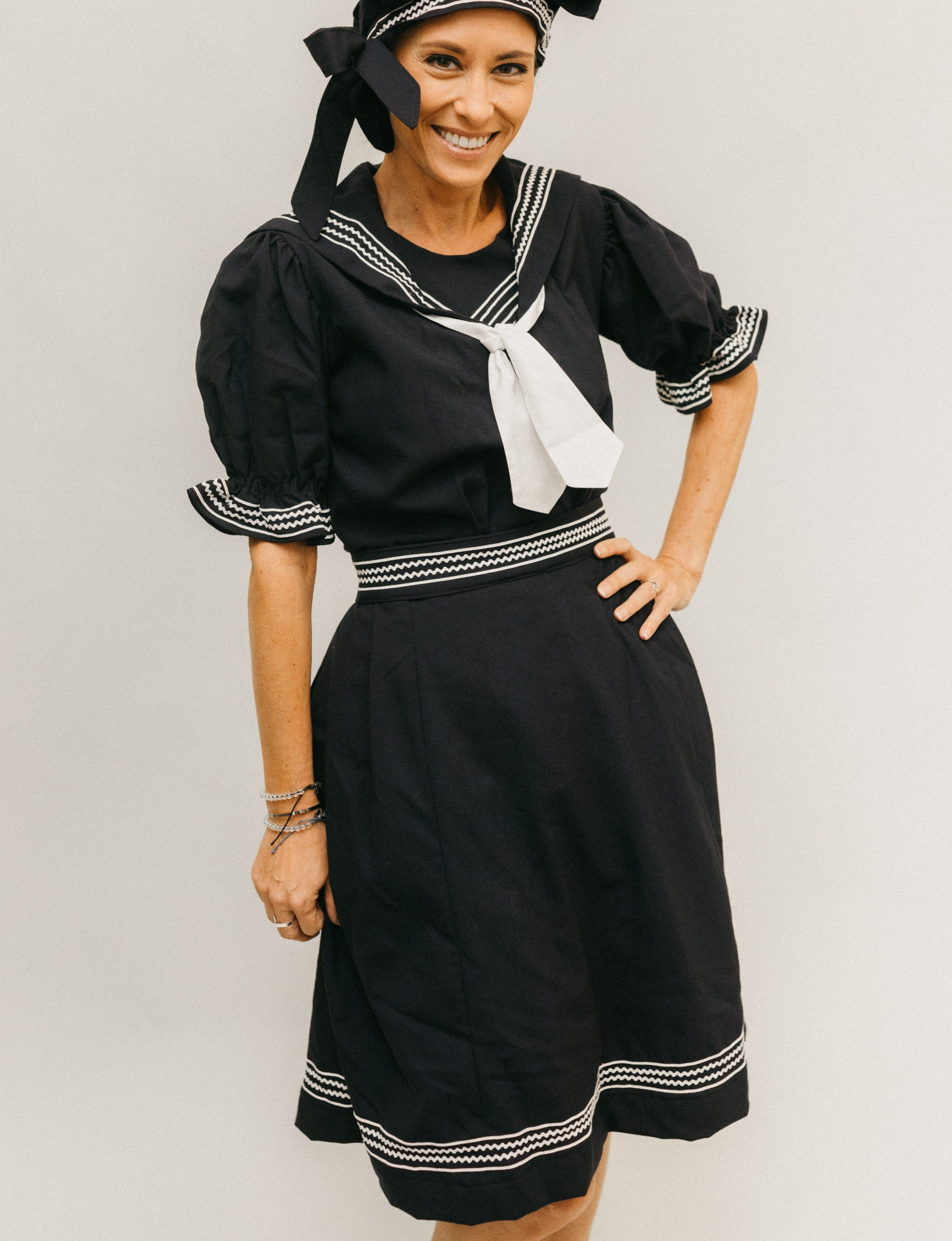 A white woman with her hand on her hip wearing 253 Vintage Bathing Costume with the jaunty cap.